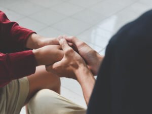 Christian couple holding hands. Two people are praying together.