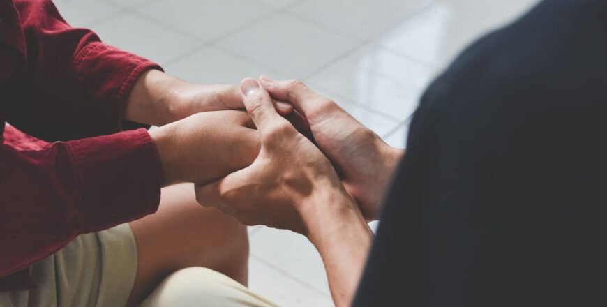 Christian couple holding hands. Two people are praying together.